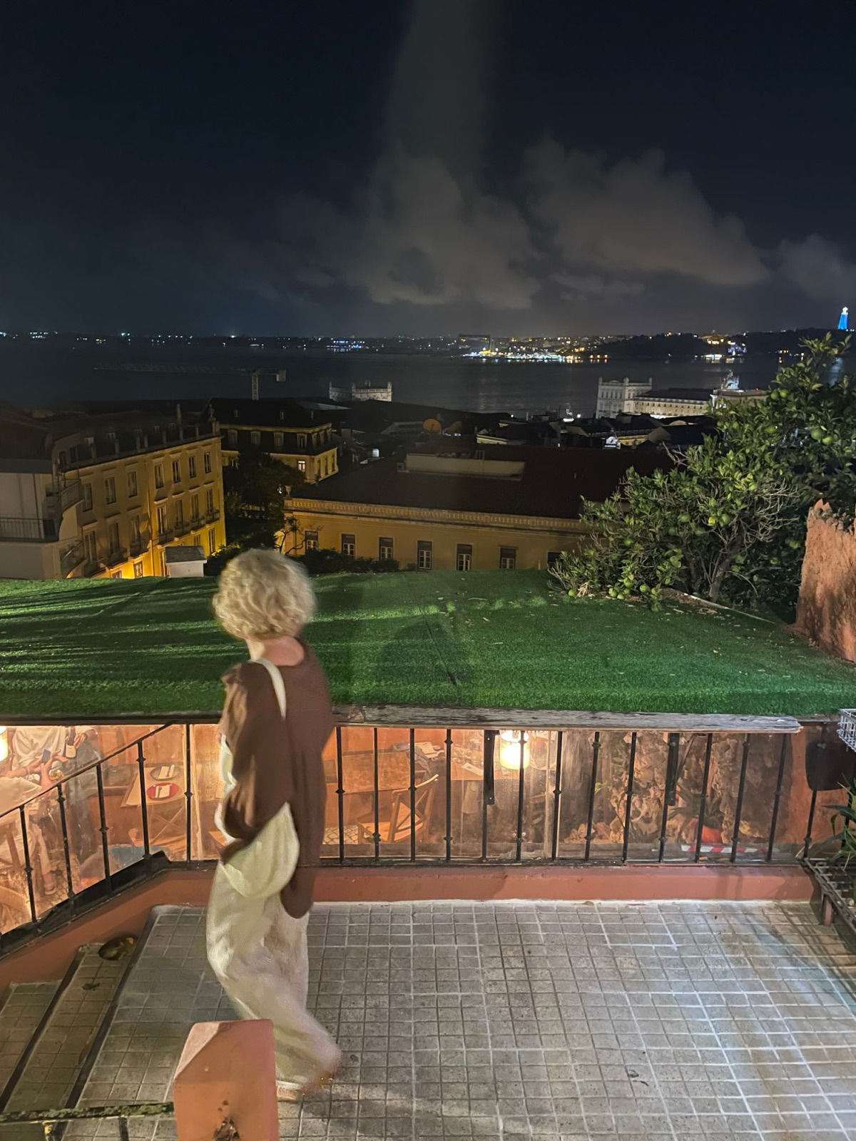 The river and the lights of Lisbon seen from a terrace at night
